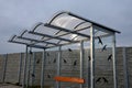 City bus stop. glass shed with integrated wooden bench. only the roof and rear wall. elegant arch roof, bus station, platform. glu Royalty Free Stock Photo