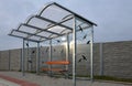 City bus stop. glass shed with integrated wooden bench. only the roof and rear wall. elegant arch roof, bus station, platform. glu