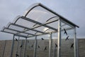 City bus stop. glass shed with integrated wooden bench. only the roof and rear wall. elegant arch roof, bus station, platform. glu Royalty Free Stock Photo