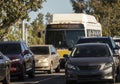 City bus in traffic with electronic sign requiring face masks due to covid-19 Royalty Free Stock Photo