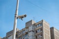 City cctv security surveillance camera system attached on the traffic light pole with clear blue sky background Royalty Free Stock Photo