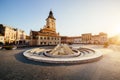 City central square (Piata Sfatului) with town council hall tower, fountain morning sunrise view, location Brasov, Transylvania, Royalty Free Stock Photo