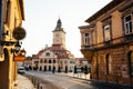 City central street with town council hall tower morning sunrise view, location Brasov, Transylvania, Romania. Famous travel Royalty Free Stock Photo