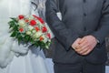 Woman and man arms, gold rings and flower bouquet. Travel photo 2014