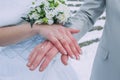 Woman and man arms, gold rings and flower bouquet. Travel photo 2014