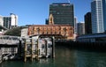 Iconic skyline of traditional Downtown Ferry Terminal and high-risers on urban shore in Auckland CBD, New Zealand