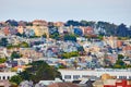 City covered in colorful housing and apartments on hill with tightly compact homes