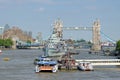 A City Cruises tour boat sails on the Thames River near Tower bridge Royalty Free Stock Photo