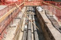 City district heating pipeline reparation and reconstruction parallel with the street with orange construction safety net or barri Royalty Free Stock Photo