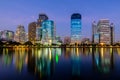 City downtown at night with reflection of skyline.