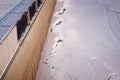 City embankment of the Amur River in winter. A large crack in the snow-covered ice along a granite wall. Reducing the water level Royalty Free Stock Photo