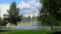 On the city embankment hung a rainbow on a sunny day.