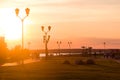 City embankment with walking people at sunset on a beautiful summer evening Royalty Free Stock Photo