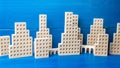 City of figures of buildings on a blue background. Concept for real estate, urban environment and transport infrastructure