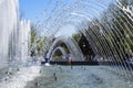 City fountain in the city of Krasnodar. People are walking by the fountain. Water splashes.