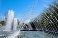 City fountain in the city of Krasnodar. People are walking by the fountain. Water splashes