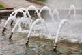 Foaming jets of water in the city`s polished granite fountain gush out from metal cannons