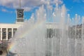 City fountain, water jets with a rainbow on a sunny day