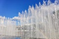 City fountain, water jets with a rainbow on a sunny day