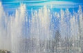 City fountain with water jets and random people, view through splashes on Sunny summer day Royalty Free Stock Photo