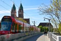 City of Freiburg, April 17, 2022, Germany - Herz-Jesu-Kirche in Freiburg im Breisgau, Black Forest with tram