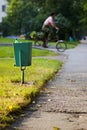 City garbage bin and cyclist Royalty Free Stock Photo
