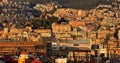 The city of Genoa at sunset seen from the harbour during a cruise.