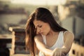 City girl brunette long hair portrait at rooftop at sunset