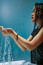 City girl flowing the water to the hand from the sink while she takes a bath in the bathroom