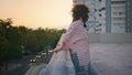 City girl posing sunset on roof. Carefree woman leaning on railings at evening Royalty Free Stock Photo