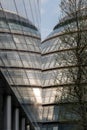 City Hall, London taken from the rear at sun down. Building is reflected in the glass facade of the adjacent building. Royalty Free Stock Photo