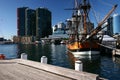 Moored historic sailing ship with iconic cityscape of modern skyscrapers on harbor waterfront, Darling Harbour, Sydney, Australia