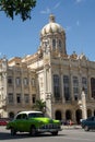 Havana, Cuba - August 26 2018: A green classic car is driving near the Museum of the Revolution in Old Havana. Royalty Free Stock Photo