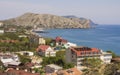 City houses on the coast of Sudak Bay.View with mountain. Royalty Free Stock Photo