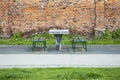City improvement. Table for playing chess and seats without people outdoors. A chess table and two benches opposite each other in