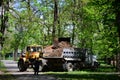 The city improvement team removes the fallen leaves in the park with an excavator and a truck. Regular seasonal work on improving