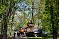 The city improvement team removes the fallen leaves in the park with an excavator and a truck. Regular seasonal work on improving