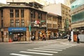 a city intersection with people walking on the sidewalk and traffic signals