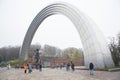 City, Kiev, Ukraine. Iron arch and monument. Tourists walk around. Travel photo