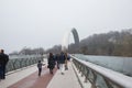 City, Kiev, Ukraine. Iron arch and monument. Tourists walk around. Travel photo