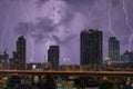 City landscape lightning storm behind clouds at night