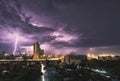 City landscape lightning storm behind clouds at night