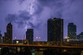 City landscape lightning storm behind clouds at night