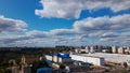 City landscape. Nearby there is a park area. Blue sky with white clouds. Aerial photography Royalty Free Stock Photo