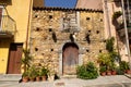 City landscape of old Sicilian Sperlinga village. Ancient sandstone house, wooden arch door. Bright sunny photo good for