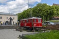 City landscape - tourist retro tram and a monument to the first printer Ivan Fedorov