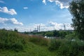 City landscape with the Uvod river with a power line and high pipes on a sunny summer day