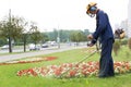 City landscaper cutting grass