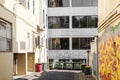 City Lane with Graffiti and Bins Reflecting Diverse Cityscape Royalty Free Stock Photo