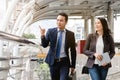 City life of asian businessman. Confident business people walking to work at office and talking together Royalty Free Stock Photo